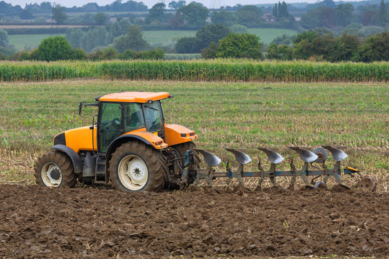 Agriculture - Tractor and Plow in a Field