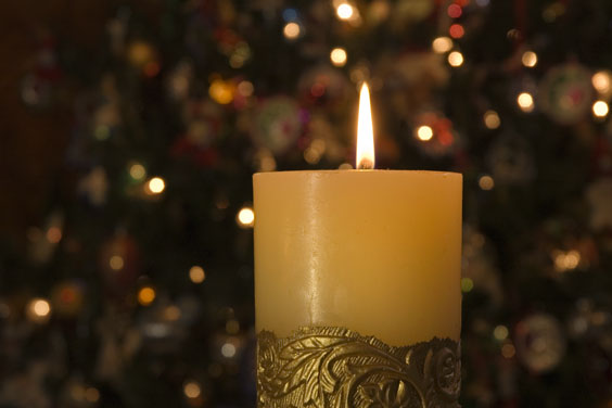 A Candle and Lights Provide Holiday Ambiance