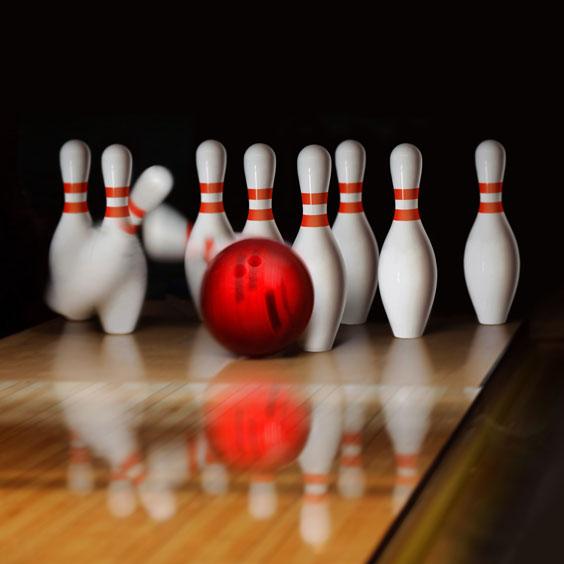 Red Bowling Ball Striking Bowling Pins