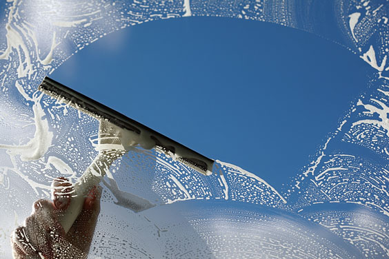 Window Cleaner Cleaning a Window