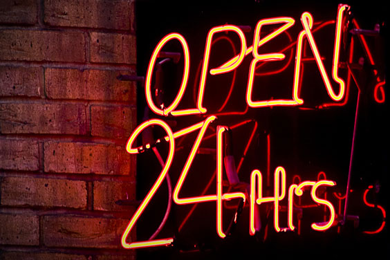 'Open 24 Hours' Sign on a Convenience Store