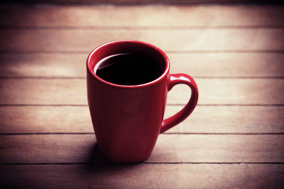 Red Cup of Coffee on a Wooden Table