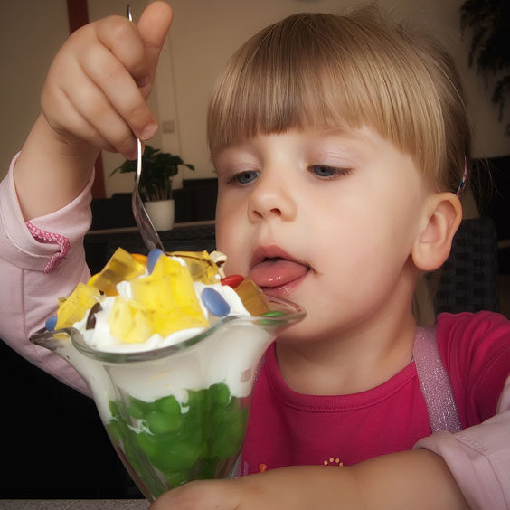 Girl Eating a Delicious Ice Cream Sundae