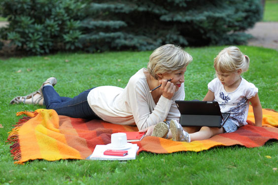 Young Child using a Tablet Outdoors