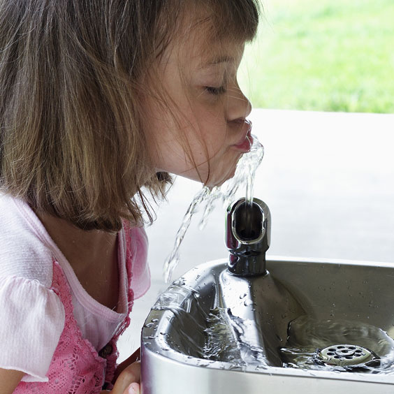 Little Girl Drinking Water from a Fountain