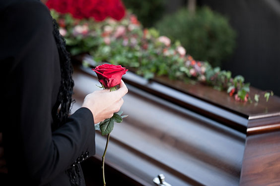 Woman Holding a Red Rose at a Funeral