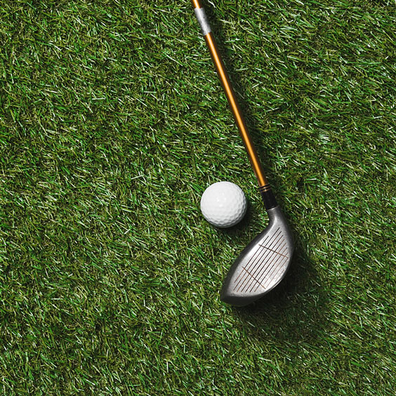 Golf Club and Golf Ball on Green Grass