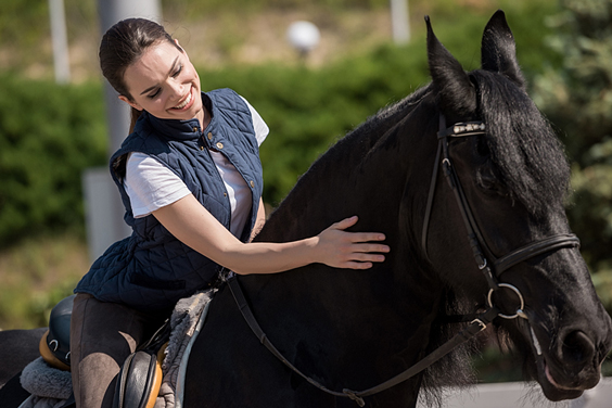 Young Woman Sitting Astride her Horse