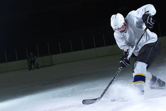 Ice Hockey Player with Stick and Puck