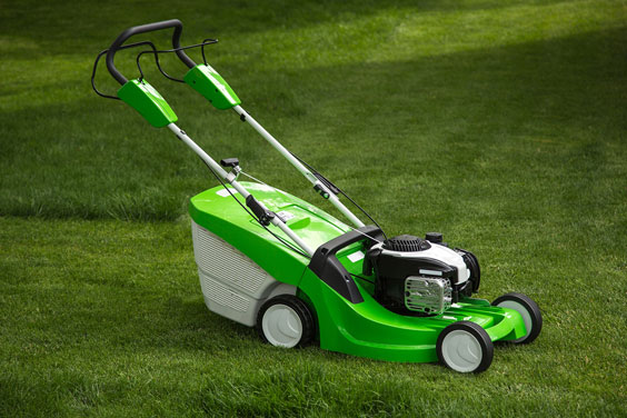 Lawn Mower on a Green Lawn