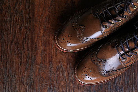 Pair of Brown Shoes on a Wood Background