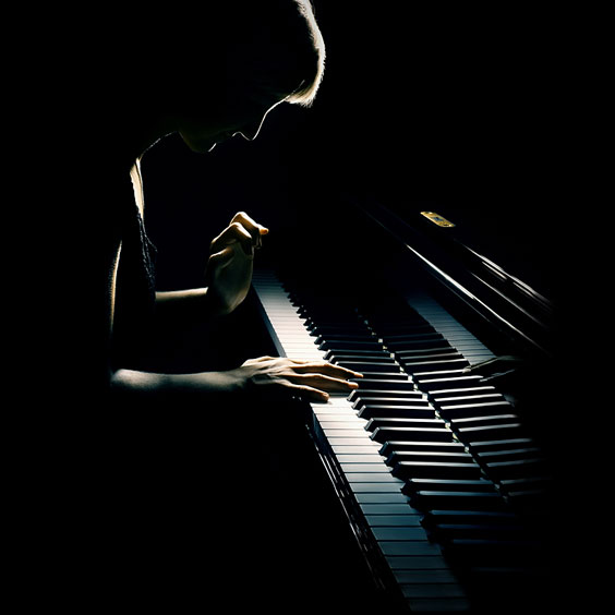 Silhouetted Pianist Playing a Piano