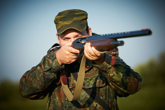 Hunter Aiming a Rifle
