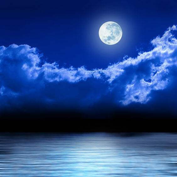 Full Moon in a Night Sky over a Calm Ocean