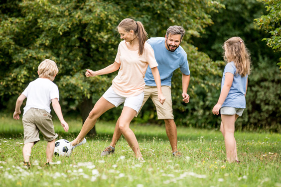 Family Playing Soccer Together