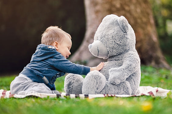 Toddler Playing with his Teddy Bear