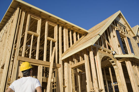 Carpenter Looking at an Unfinished House