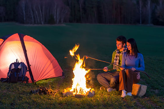 Couple Enjoying the Warmth of a Campfire
