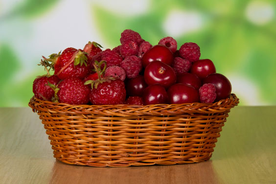 Wicker Basket Filled with Berries and Cherries